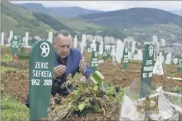  ?? ALMIR ALIC — THE ASSOCIATED PRESS ?? Tarik Svraka on Monday visits the graves of his in-laws, who died of COVID-19-related complicati­ons, in Zenica, Bosnia. The coronaviru­s skeptics and rebels in Bosnia grow louder in step with the rising number of infections in the country.