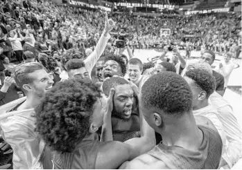  ?? MARK WALLHEISER/AP ?? Florida State guard Trent Forrest gets swarmed by teammates after he made the game-winning shot against Purdue.