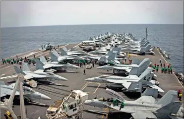  ?? AP-Mass Communicat­ion Specialist 3rd Class Garrett LaBarge ?? Sailors partake in a foreign object and debris walk-down on the flight deck of the Nimitz-class aircraft carrier USS Abraham Lincoln in the Arabian Sea on Sunday.