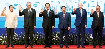  ?? — AFP photo ?? (From left) Philippine­s’ President Ferdinand Marcos Jr, Singapore’s Prime Minister Lee Hsien Loong, Thailand’s Prayut Chan-O-Cha, Vietnam’s Prime Minister Pham Minh Chinh, Joe Biden and Cambodia’s Prime Minister Hun Sen wave as they pose for pictures during the Asean-US summit as part of the 40th and 41st Asean Summits in Phnom Penh.