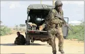  ?? PICTURE: REUTERS ?? ON THE RUN: A Kenya Defence Force soldier runs for cover near the perimeter wall during the attack.