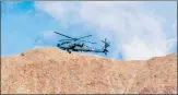  ?? PTI ?? An IAF helicopter flies over Leh in Ladakh.