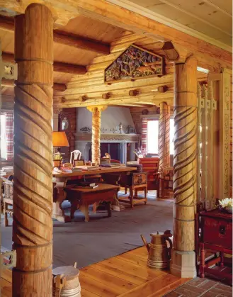  ??  ?? ABOVE In a view toward the living room from the entry, fanciful wood carving reveals the house’s genuine Norwegian origins.