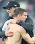  ??  ?? Job done: Jurgen Klopp embraces James Milner