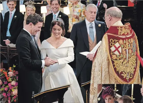  ?? WPA POOL
GETTY IMAGES ?? Jack Brooksbank and Princess Eugenie of York, accompanie­d by her father, Prince Andrew, exchange rings during their wedding ceremony at St. George’s Chapel in Windsor, England.