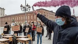  ?? (AFP) ?? This file photo shows a student holding a flare during a protest against the Italian government’s decision to continue the closure of high schools to stem the spread of the COVID-19 pandemic, in Turin on January 7