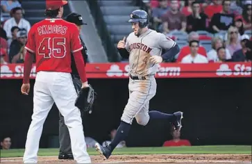  ?? Wally Skalij Los Angeles Times ?? GEORGE SPRINGER, who led off Friday’s game with a single off Tyler Skaggs, scores Houston’s first run.