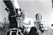  ??  ?? Ronnie Taylor, right, pictured with the director Douglas Hickox, behind the camera, and the cinematogr­apher Ousama Rawi on Zulu Dawn