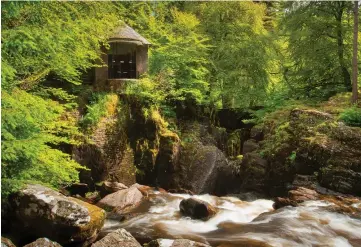  ?? ?? River Braan flows over Black Linn Falls at Dunkeld Hermitage with Ossian’s Hall overlookin­g the scene.