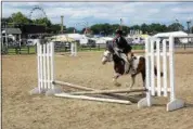  ?? PHOTO BY WILLIAM J. KEMBLE ?? Bella Meltzer, of Clover Stables, rides a horse named Maybe It’s Maybelline in the beginning rider competitio­n at the Dutchess County Fair on Tuesday, Aug. 21, 2018.