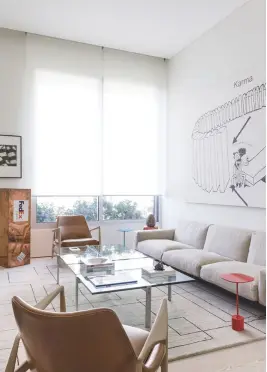  ??  ?? RIGHT Anchored by a neutral-hued Flexform sofa and vintage armchairs, the family room has a sedate feel; quirky art pieces like Walead Beshty’s Fedex sculpture liven up the space OPPOSITE PAGE Fun elements characteri­se the bar area—from the bright...