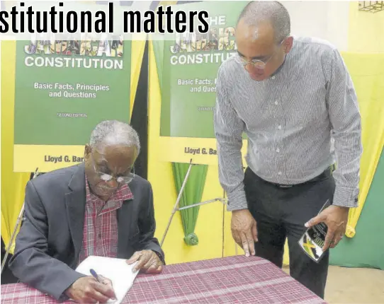  ?? ?? Dr Lloyd Barnett signs a copy of his book for attorney-at-law Peter Champagnie at the book launch held at St Luke’s Church in St Andrew last Thrusday.