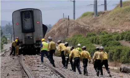  ?? Photograph: Dean Musgrove/AP ?? First responders work the scene after a derailed Amtrak train in Moorpark, California, on Wednesday.