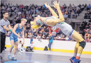  ?? ROBERTO E. ROSALES/JOURNAL ?? Rio Rancho’s Tim Lopez, right, does a backflip after defeating Cleveland’s Isaiah Trujillo to win the state championsh­ip Saturday at Santa Ana Star Center.