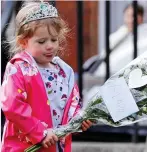  ??  ?? Emotional: A woman in a Union Jack mask… and a young girl in a tiara
