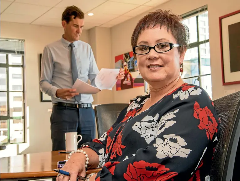  ??  ?? Waveney Parkinson has been the senior executive assistant to four mayors of Wellington, including current mayor Justin Lester, at back. Photos: JOHN NICHOLSON/FAIRFAX NZ