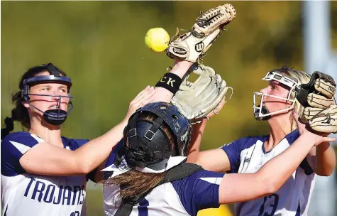  ?? STAFF PHOTO BY ROBIN RUDD ?? From left, Soddy-Daisy third baseman Hope Ingle, catcher Jayde Baron (9) and pitcher Taylor Lloyd go after a pop up during Monday’s game against Walker Valley. After bouncing among the three, Lloyd came up with the ball for the out.