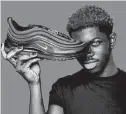  ?? MSCHF / New York Times ?? Lil Nas X with his Satan Shoes, a collaborat­ion between the company MSCHF and the rapper.