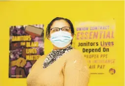  ??  ?? Janitor Gloria Espinoza, who was laid off in April and has struggled since then, worries that she might not have a job to return to.