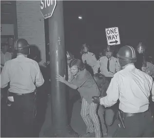  ?? GLENN BAGLO/ VANCOUVER SUN FILES ?? Police arrest protesters during the Gastown Riot in August 1971. Defence lawyer Josiah Wood represente­d those charged, who claimed that police used excessive force during the arrests.