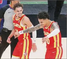  ?? Curtis Compton / Associated Press ?? Atlanta’s Trae Young, left, celebrates with John Collins Wednesday, when the Hawks clinched a playoff berth.