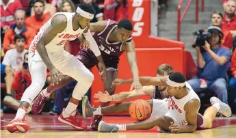  ?? ADOLPHE PIERRE-LOUIS/JOURNAL ?? UNM’s Carlton Bragg (left), Montana’s Jared Samuelson and Mack Anderson, and Lobo J.J. Caldwell battle for a loose ball at the Pit last December. Bragg and Caldwell were suspended later in the month.