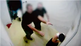  ??  ?? A boy allegedly being pushed by prison guards at a youth detention centre in the Northern Territory city of Darwin. —