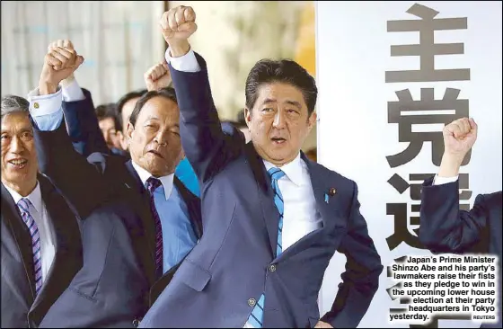  ?? ReuTeRS ?? Japan’s Prime Minister Shinzo Abe and his party’s lawmakers raise their fists as they pledge to win in the upcoming lower house election at their party headquarte­rs in Tokyo yesterday.