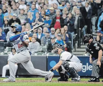  ?? ROBERT GAUTHIER LOS ANGELES TIMES ?? Los Angeles Dodgers’ Yasiel Puig hits a three-run home run in the sixth inning against the Brewers in Game 7 of the National League Championsh­ip Series at Miller Park in Milwaukee on Saturday night.