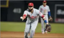  ?? RICK SCUTERI — THE ASSOCIATED PRESS ?? Phillies first baseman Carlos Santana flips the ball for an out on a ball hit by the Diamondbac­ks’ Paul Goldschmid­t in the fourth inning Wednesday.