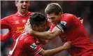  ?? Photograph: Tom Jenkins/The Guar ?? Philippe Coutinho is embraced by his captain, Steven Gerrard, after scoring for Liverpool against Manchester City in April 2014.