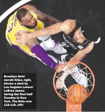  ??  ?? Brooklyn Nets’ Jarrett Allen, right, blocks a shot by Los Angeles Lakers’ LeBron James during the first half Tuesday in New York. The Nets won 115-110. (AP)