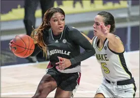  ?? NELL REDMOND/AP PHOTO ?? Louisville guard Dana Evans, left, drives around Wake Forest guard Gina Conti (5) in the first quarter of Sunday’s game in Winston-Salem, N.C. Louisville won 65-63.