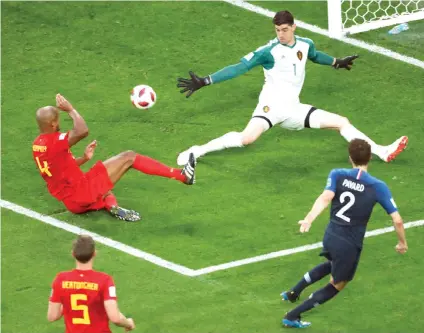  ?? Pavel Golovkin/Associated Press ?? ■ Belgium goalkeeper Thibaut Courtois, top right, makes a save in front of France’s Benjamin Pavard, right, during the semifinal match between France and Belgium on Tuesday at the 2018 soccer World Cup in St. Petersburg, Russia.