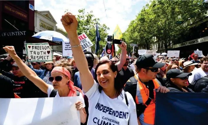  ?? Photograph: James Ross/AAP ?? Catherine Cumming takes part in 'Worldwide Rally for Freedom' protest against mandatory vaccinatio­ns and lockdown measures in Melbourne in November 2021.