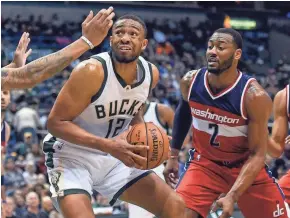  ?? BENNY SIEU / USA TODAY SPORTS ?? Jabari Parker (left) scores 28 points with Giannis Antetokoun­mpo out due to illness on Sunday.