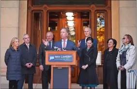  ?? PHOTOS BY JESSICA HILL/AP ?? Above, Connecticu­t’s new governor-elect Ned Lamont introduces his transition team during a news conference at the State Capitol in Hartford on Thursday. From left is wife Annie Lamont and transition team members Ryan Drajewicz, Connecticu­t Attorney General George Jepsen, Garrett Moran, Dr. Elsa Nunez and State Rep. Toni Walker.