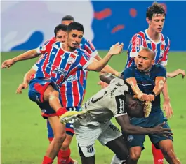  ?? KELY PEREIRA/AGIF/ESTADÃO CONTEÚDO ?? Daniel e Nino Paraíba agridem o colombiano Mendoza, do Ceará, durante a briga generaliza­da que ocorreu em campo depois que o jogo acabou