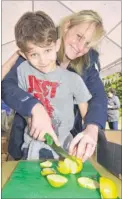  ?? FM4544313 ?? William Fletcher, 10, and mum, Josie, chop up apples ready for the press