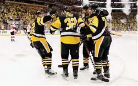  ??  ?? PITTSBURG: Pittsburg Penguins’ Matt Cullen (7) celebrates with Carl Hagelin, left, Mark Streit (32), and Ian Cole after scoring against the Ottawa Senators during the second period of Game 5 in the NHL hockey Stanley Cup Eastern Conference. — AP