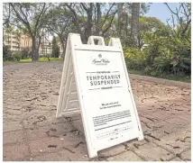  ??  ?? A sign reading ‘Temporaril­y Suspended’ is seen outside the Grand Wailea Maui in Wailea.