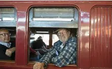  ??  ?? Terry Wareham looks out the window as a steam train pulls into the station.