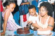  ??  ?? MEMORIES: Zoleka with her late daughter Zenani and son Zwelami at his first birthday party in 2003