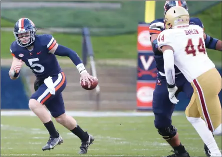  ?? MATT RILEY/UVA Media Relations ?? University of Virginia quarterbac­k Brennan Armstrong, a Shelby High graduate, runs for additional yardage in the Cavaliers’ 43-32 win over Boston College.