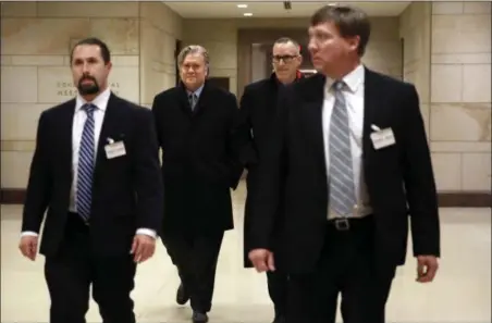  ?? JACQUELYN MARTIN — THE ASSOCIATED PRESS ?? Former White House strategist Steve Bannon, second from left, is escorted from a House Intelligen­ce Committee meeting where he was interviewe­d behind closed doors on Capitol Hill, Tuesday in Washington.