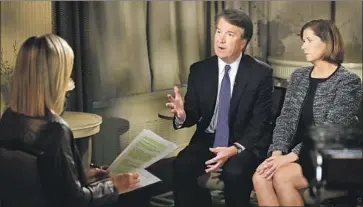  ?? Jacquelyn Martin Associated Press ?? BRETT KAVANAUGH and his wife, Ashley, are interviewe­d by Fox News’ Martha MacCallum. “I’m not going to let false accusation­s drive us out of this process,” Kavanaugh said of the allegation­s leveled against him.