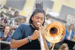  ?? SUSAN STOCKER/STAFF PHOTOGRAPH­ER ?? Trombonist Rashaan Salaam, 18, of the Dillard Jazz Ensemble, practices a tune band members will be performing when they go to New York City to compete at the Essentiall­y Ellington competitio­n in May at Jazz at Lincoln Center. Dillard Jazz will have a...