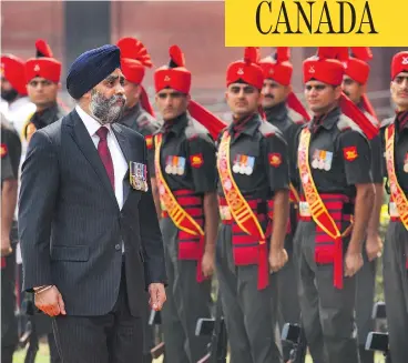  ?? MANISH SWARUP / THE ASSOCIATED PRESS ?? Defence Minister Harjit Sajjan, inspecting an honour guard in New Delhi, India on April 18, says he personally inserted comments into a speech he made that day inflating his role in a key 2006 Afghanista­n battle.