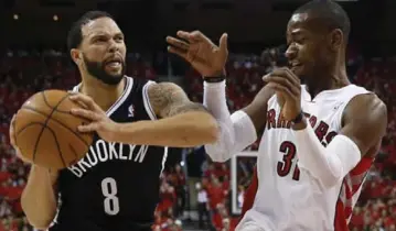  ?? RICK MADONIK/TORONTO STAR ?? Raptor Terrence Ross, right, defends against the Nets’ Deron Williams during second-half action Sunday at the ACC.