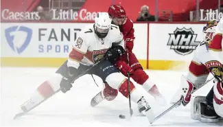  ?? PAUL SANCYA AP ?? Panthers defenseman Radko Gudas blocks out Detroit’s Sam Gagner in front of the Florida net to aid goalie Chris Driedger, who improved to 6-1-1 this season.